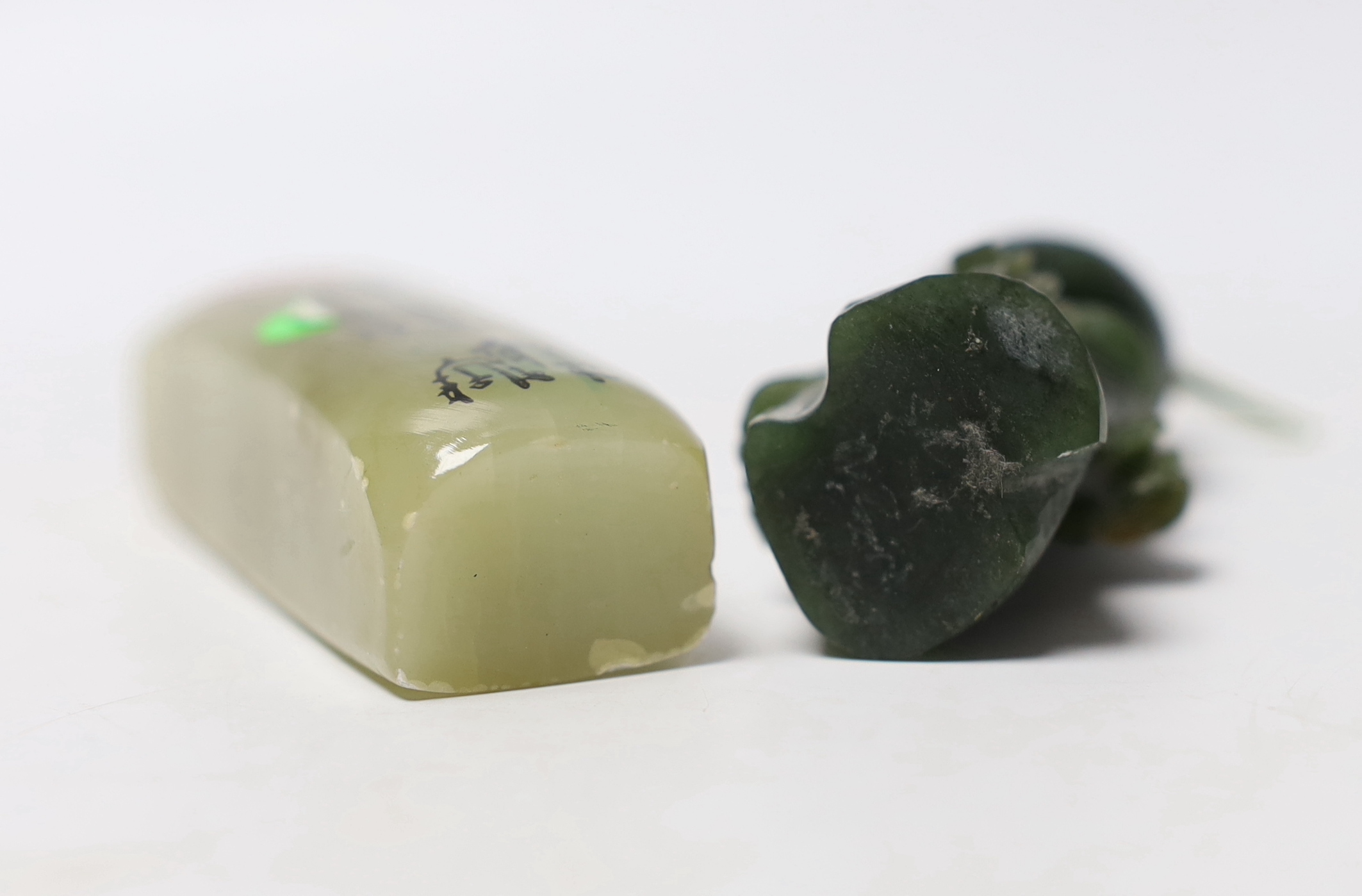 A carved spinach green jade model of a bird and a Chinese soapstone scroll weight, largest 7cm high